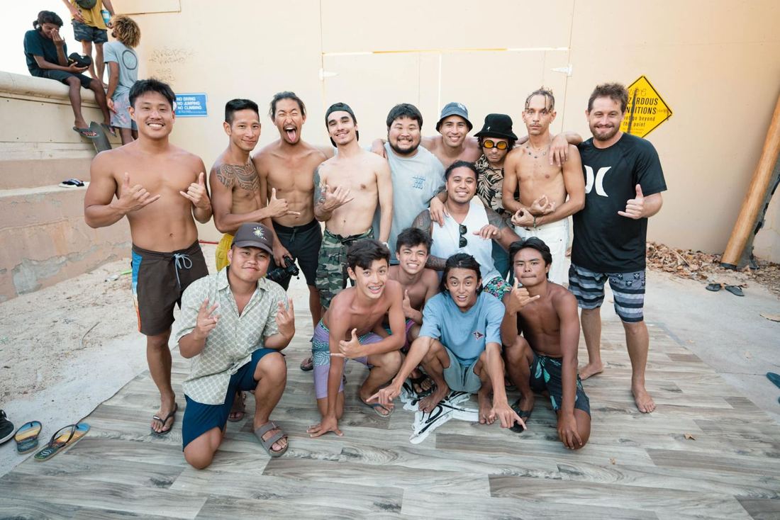 Members of the 808 Breakers crew, young and old, pose together throwing shakas.